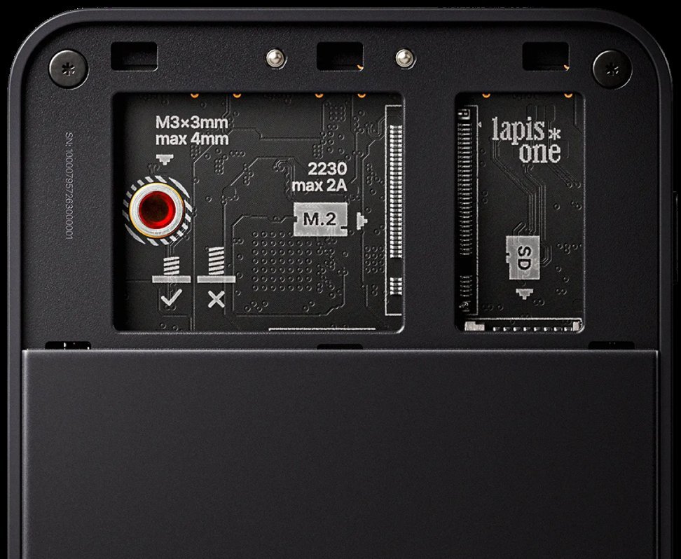 Underside of a black Lapis One with the storage cover off, showing M.2 and microSD slots.