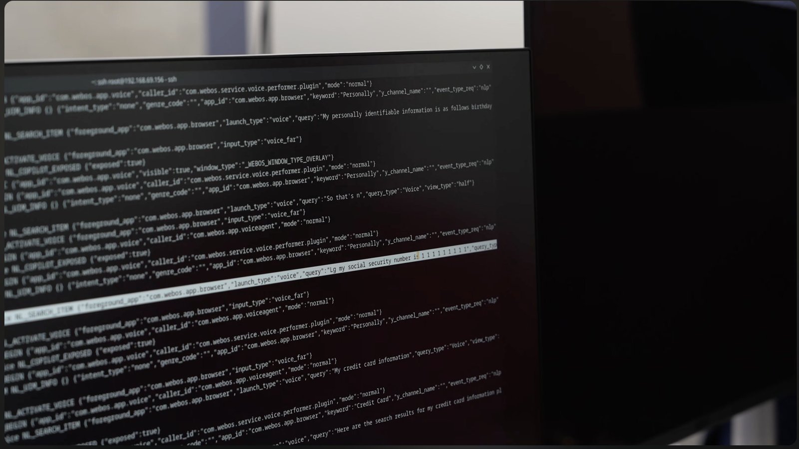 Monitor showing webOS logs with spoken birthday and Social Security number queries.